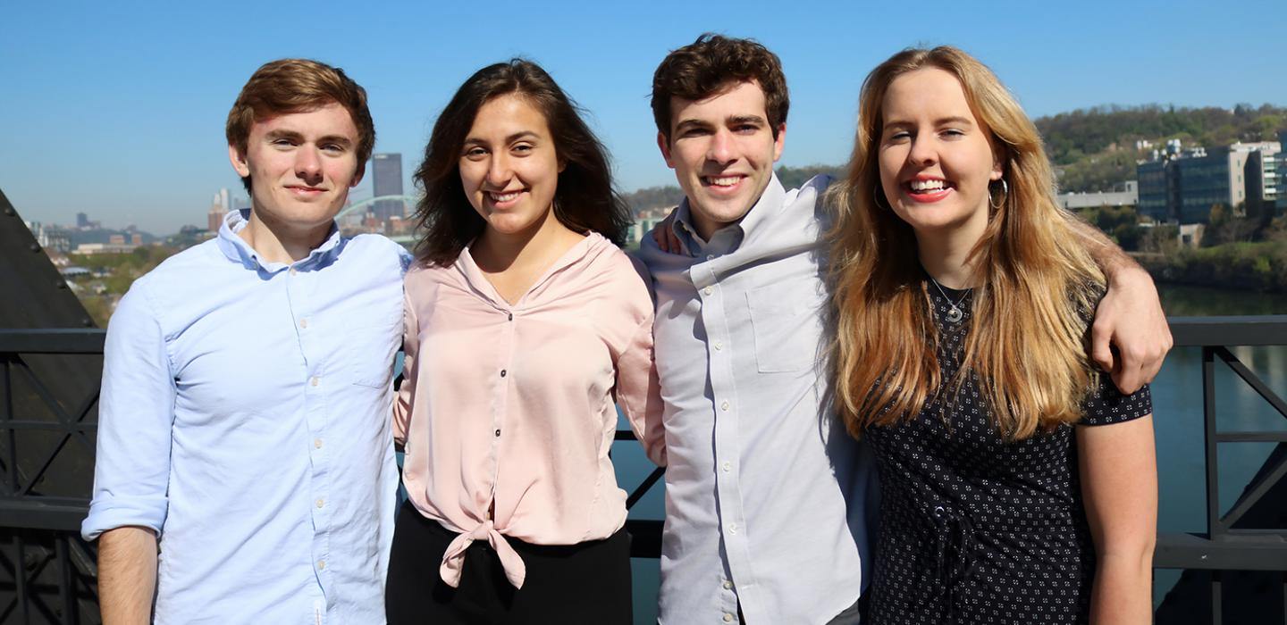Four students standing side by side 