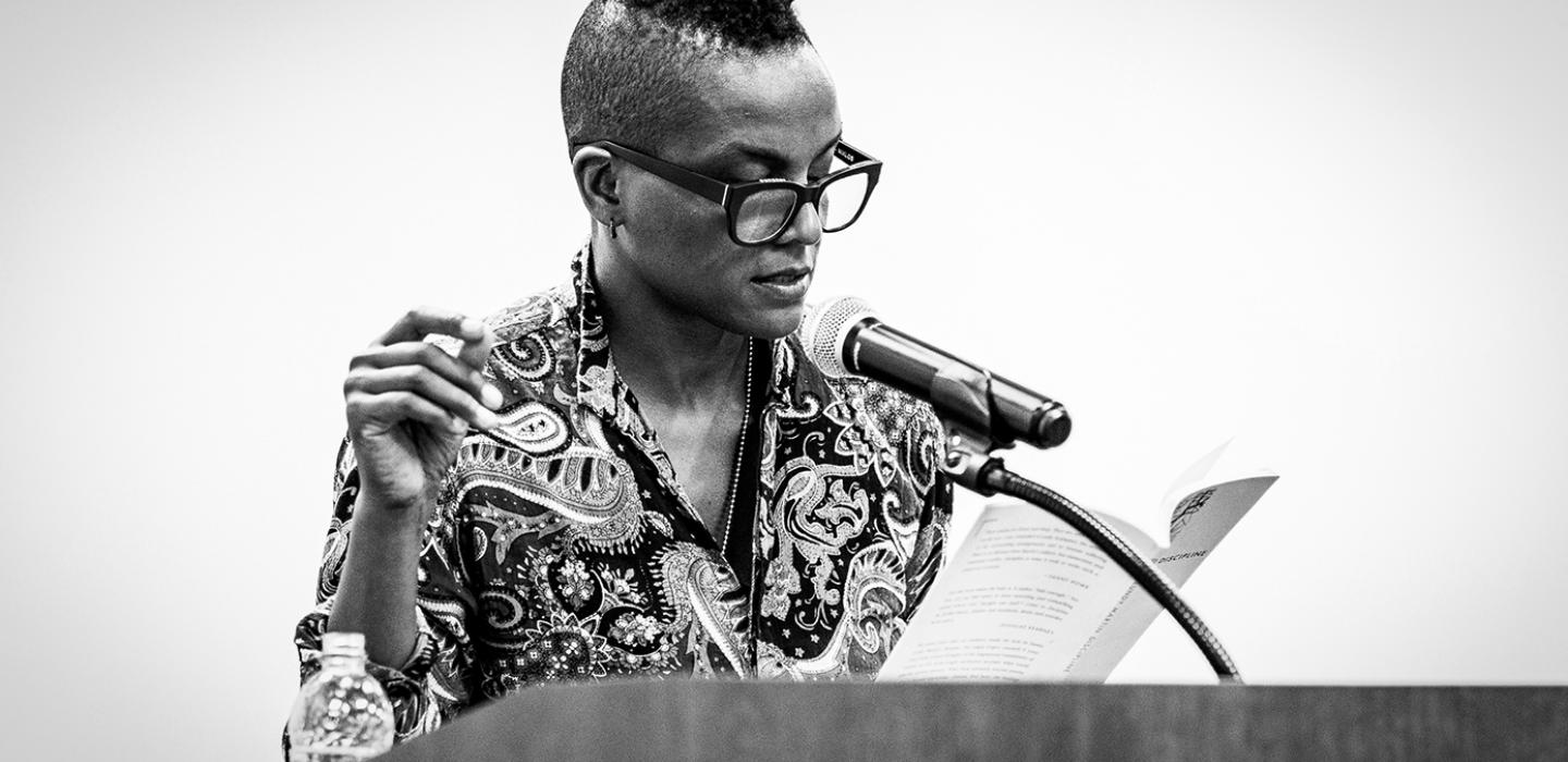 A person in a black and white photo with a patterned dress shirt