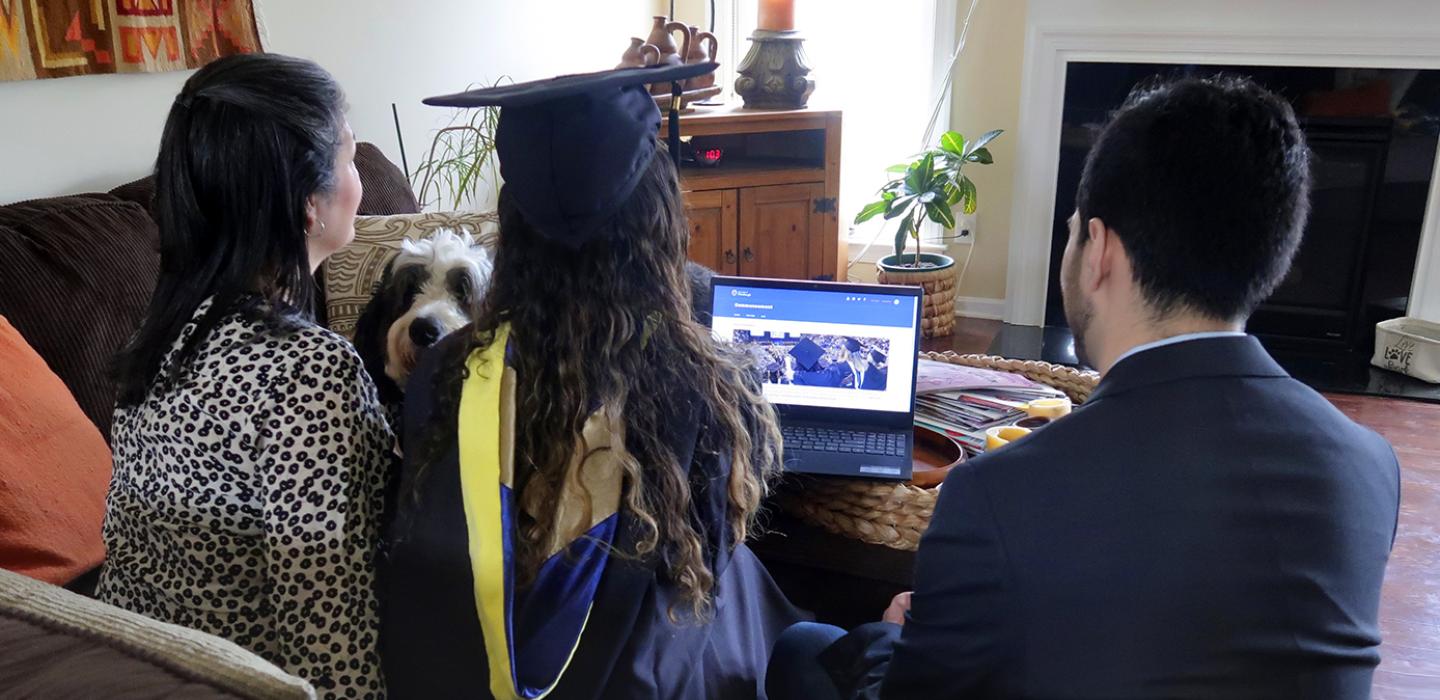 A family watches commencement online 