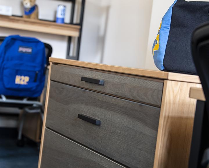 Dorm furniture covered in Pitt emblemed items
