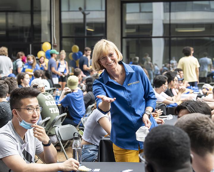 Mary Besterfield-Sacre welcomes students throughout the Benedum Hall courtyard