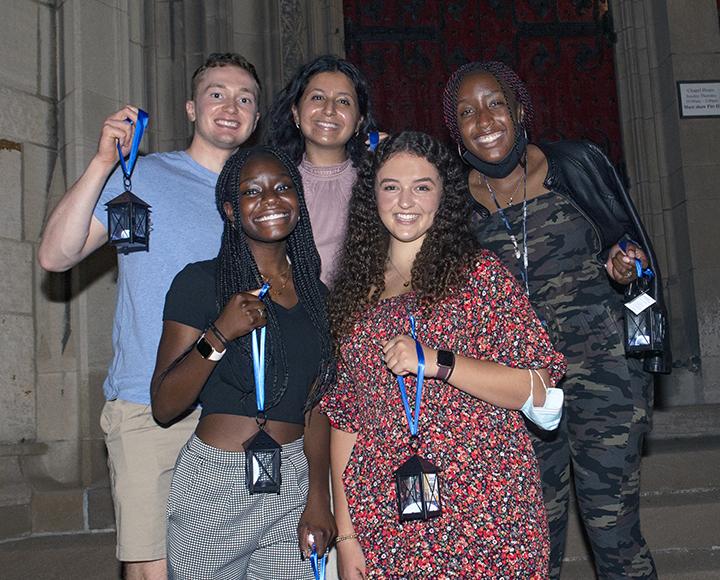 5 students hold lanterns