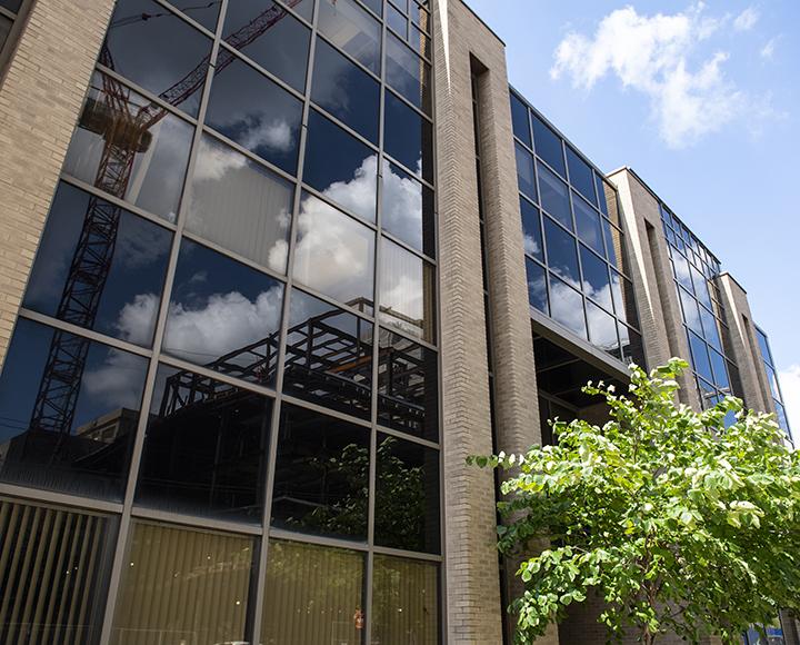 Salk Hall windows reflecting construction