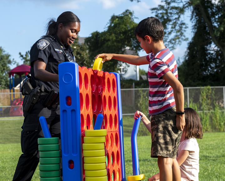 Grayson Kossis plays game with Police Officer Jamie Cunningham.