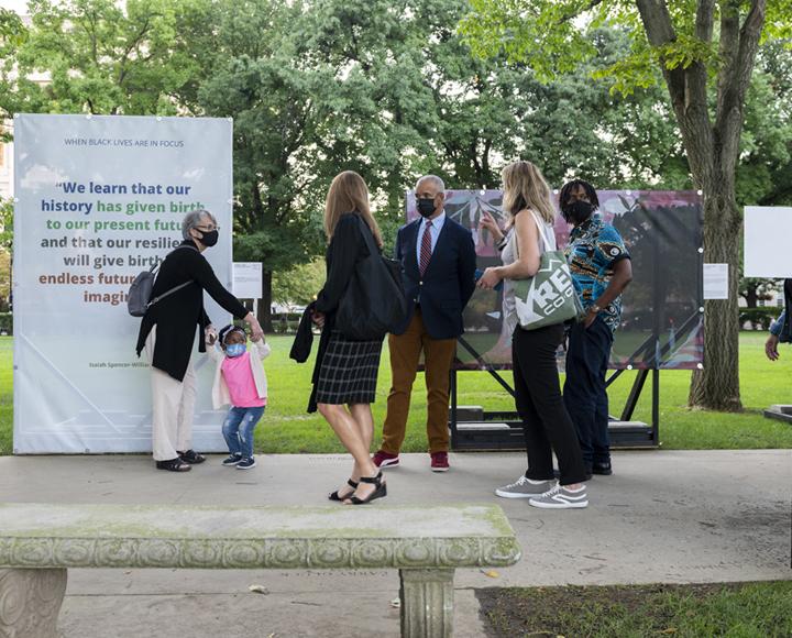 Attendees stand in front of exhibits at Black Lives in Focus Gallery