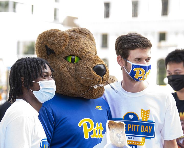 Jamal Johnson and Jonathan Levy posing for photo with Panther mascot.