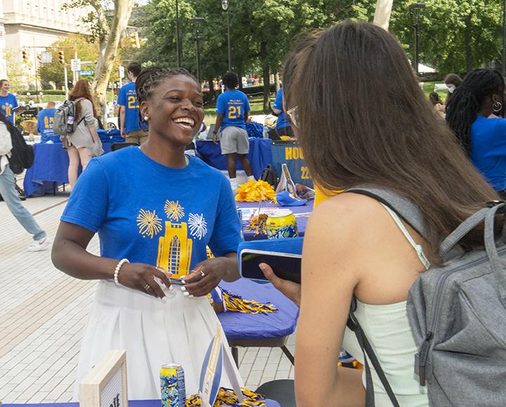 De'ovia Davis talking and laughing with Pitt student