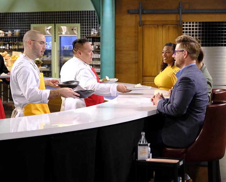 Brett Bankson on Top Chef, handing plates to judges
