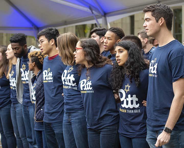 Crowd with navy blue Pitt shirts gathered at Tree of Life vigil