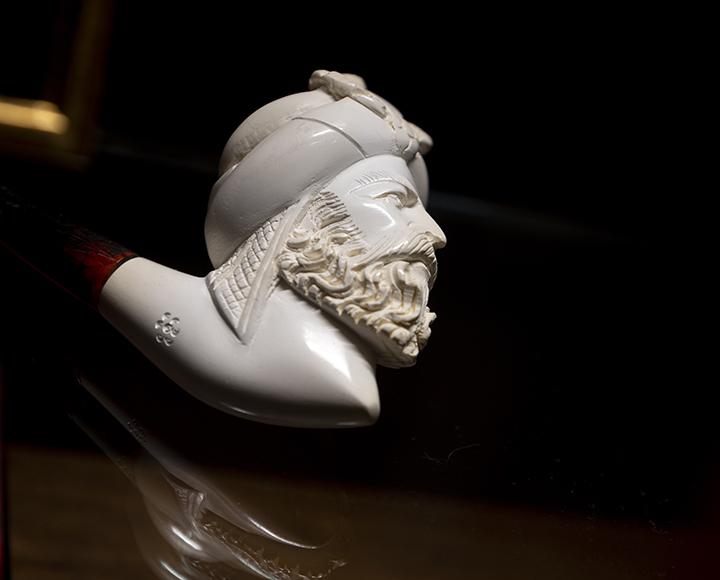 Small white head figure in dark room