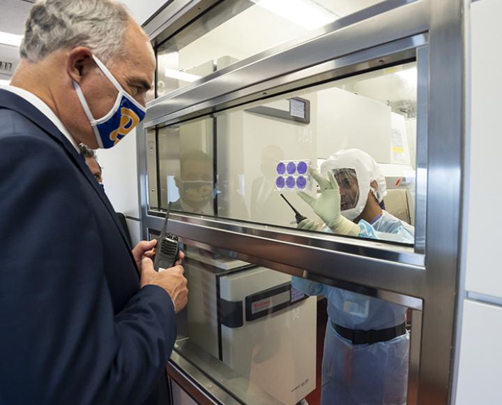 Sham Nambulli shows Bob Casey various samples of coronavirus in petri dishes