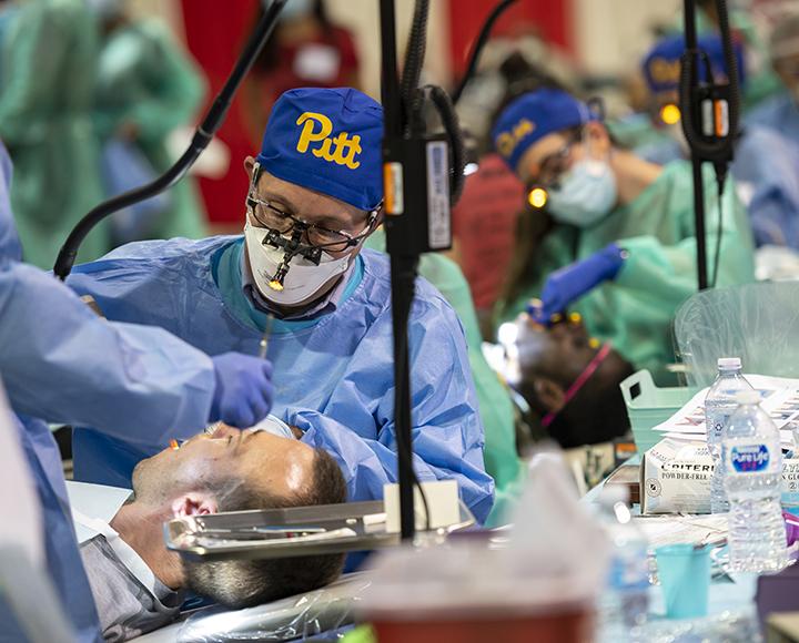School of Dental Medicine volunteers working on patient