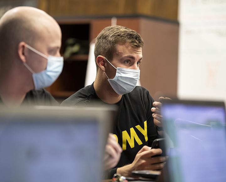 Matthew Starinsky wearing a face mask and presenting during a meeting