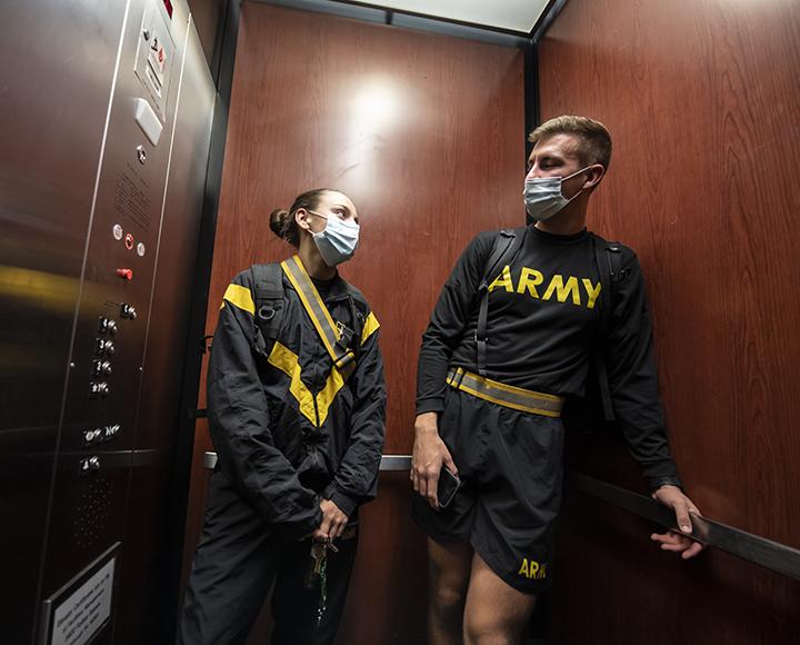 Matthew Starinsky talking to Marlo Guastella in an elevator