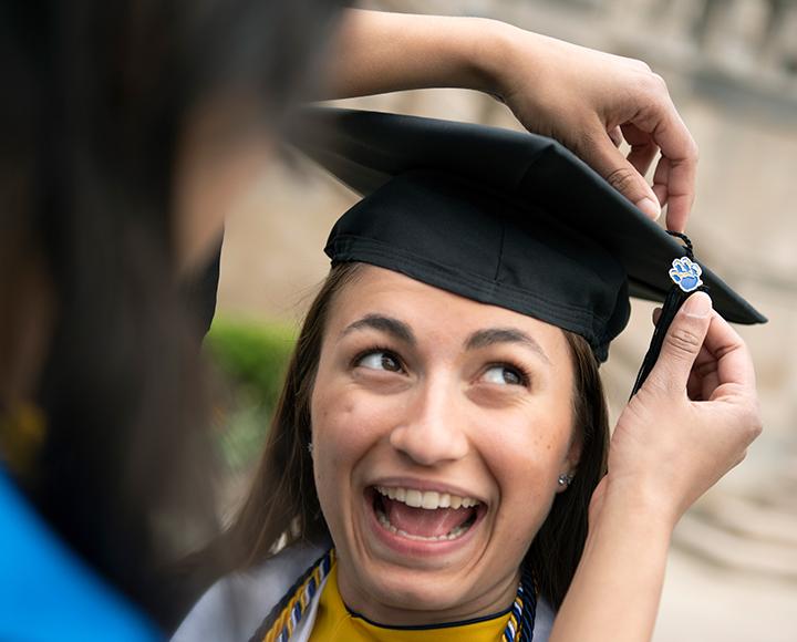 Miller joyous and wearing a mortar board