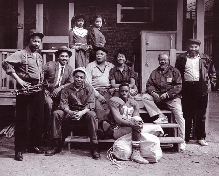 a group of people posed on a stage