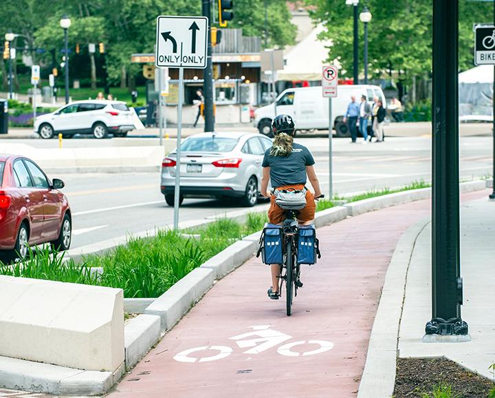 a person cycling on a protected bike lane