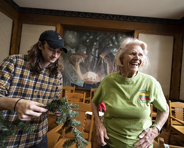 a person holding a garland next to a smiling woman