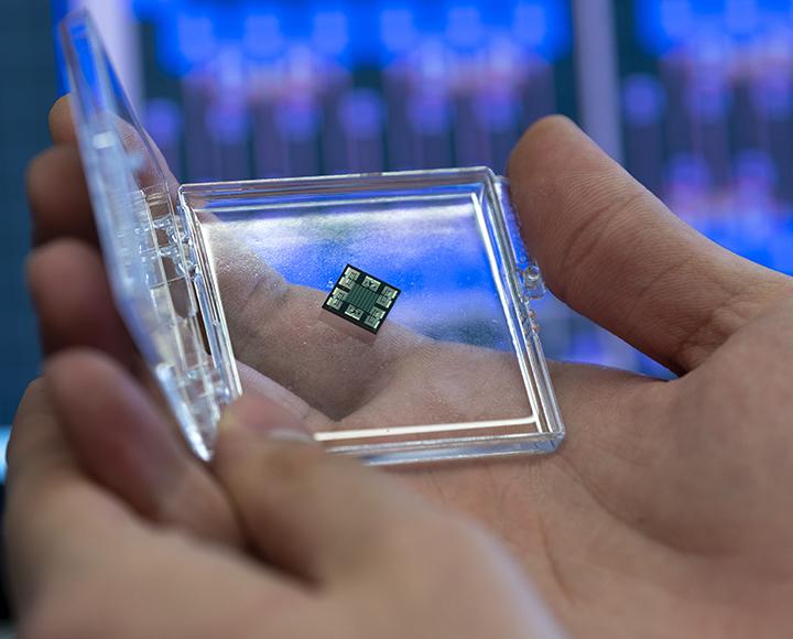A small device is held in an open plastic container.