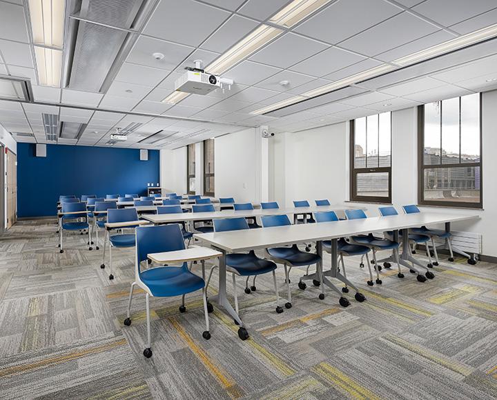 A classroom with rows of long desks