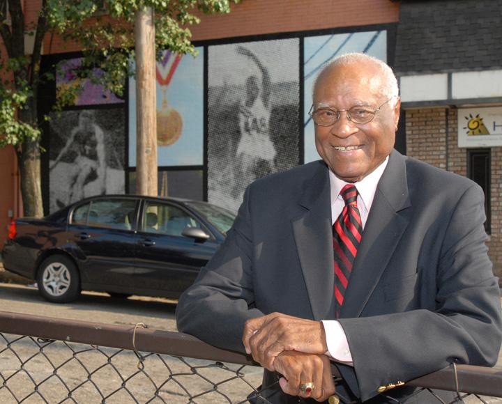 Herb Douglas poses near his mural