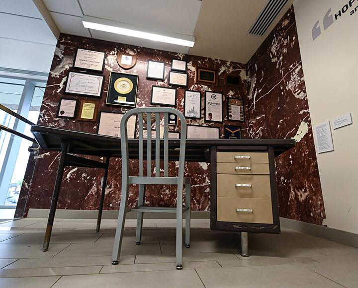 A desk next to a wall of archival documents