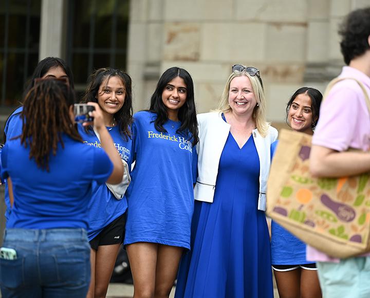 a person photographing a line of people in blue