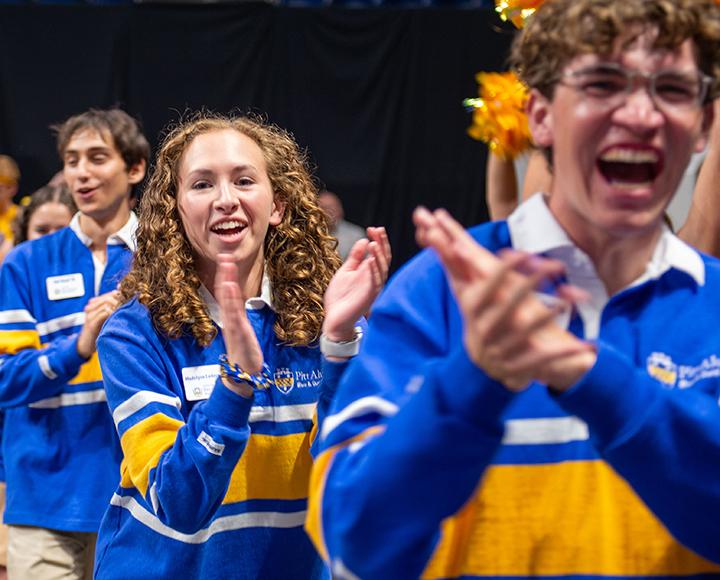 students in blue and gold cheering