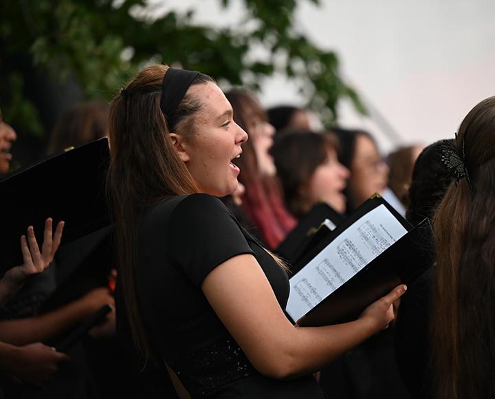 a woman in black singing