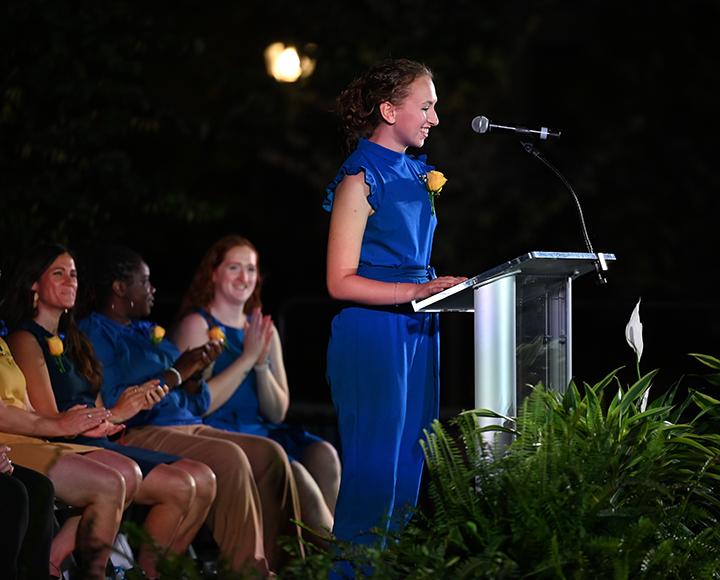 a speaker in royal blue at a podium