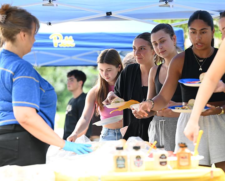People stand in line for food