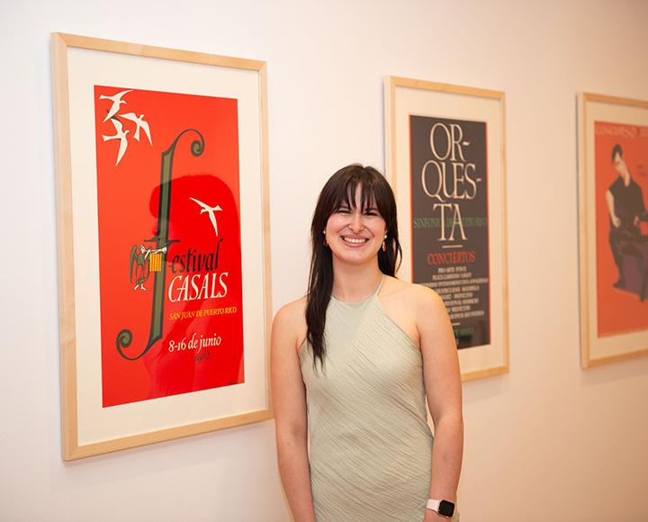 Castillo stands by a wall with three framed posters