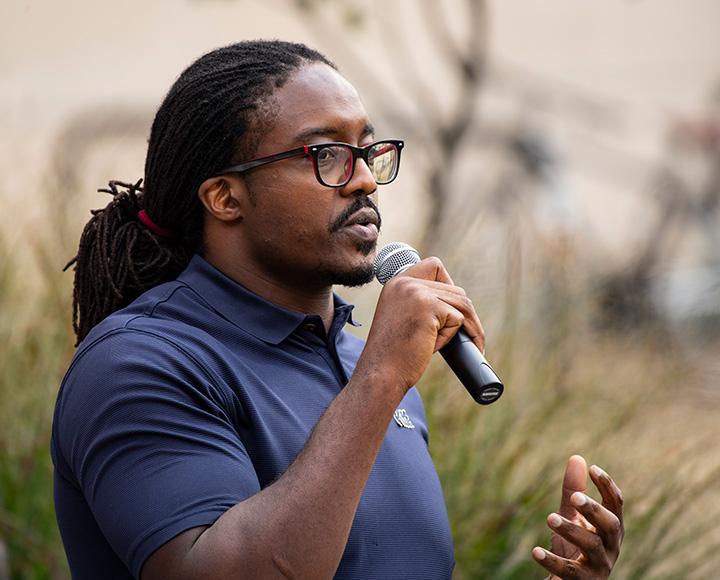 Idoko speaks into a microphone
