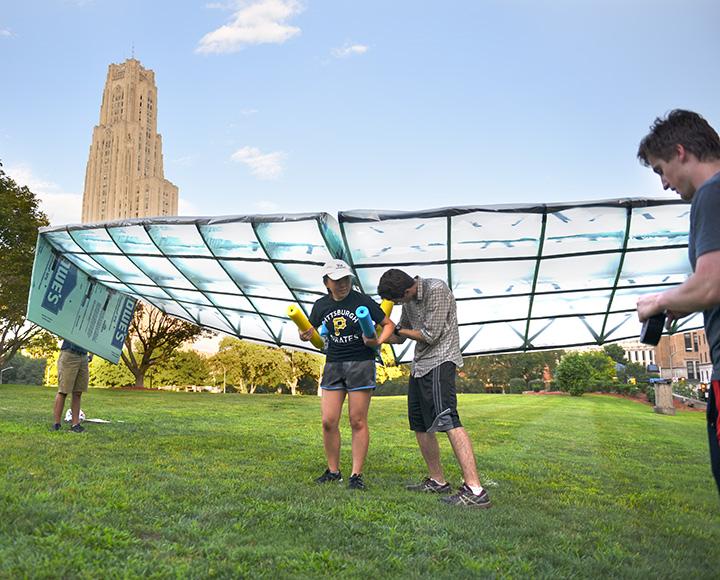 People affix a glider to a person's back