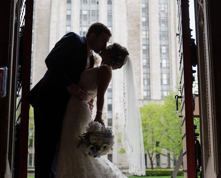 A couple kisses in the Heinz Memorial Chapel doorway