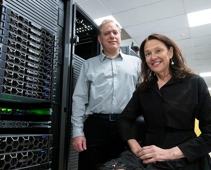 Silverstein and Metis stand in front of the computer system