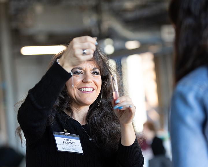 A person holds a micropipette over a test tube