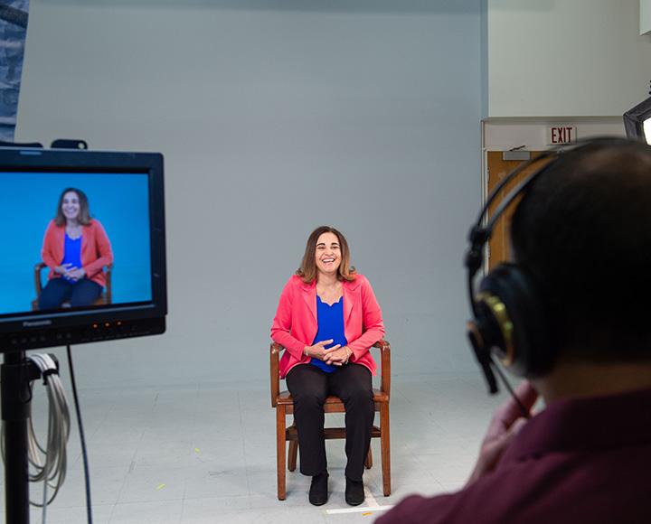 Subject Adriana sits for an interview with the CuPID team, smiling.