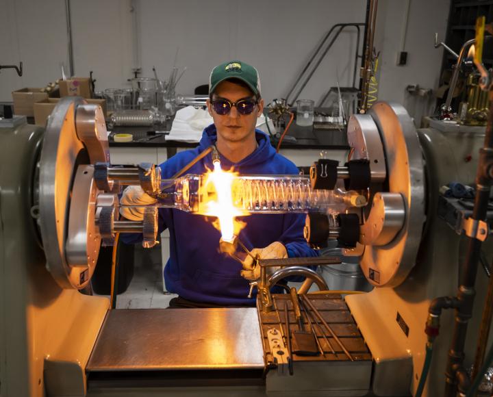 Ryan Tate works on a glass apparatus