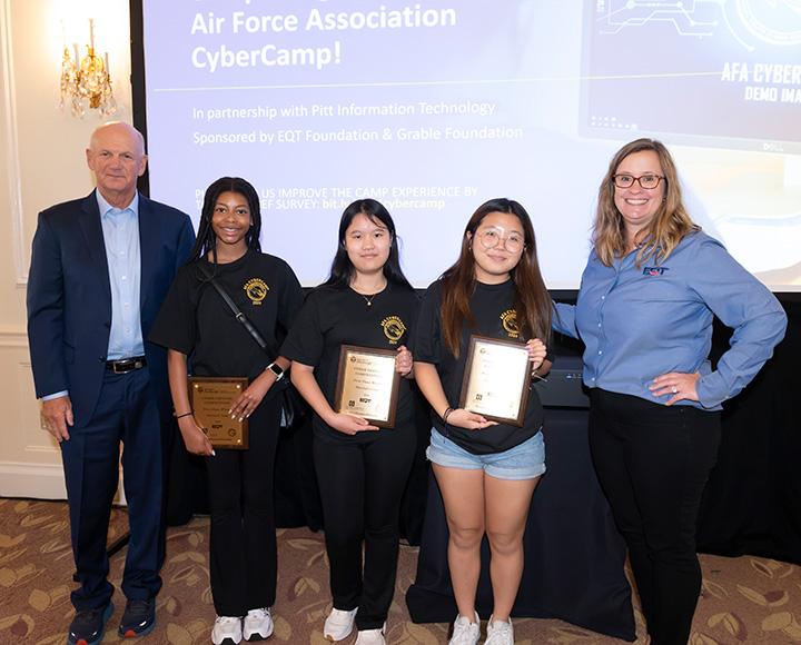 Winners of the Pitt CyberCamp hacking simulation competition pose with their awards.
