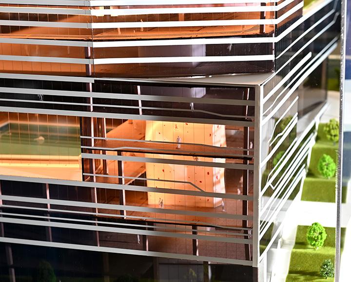 A rock-climbing wall and pool within the campus recreation center model
