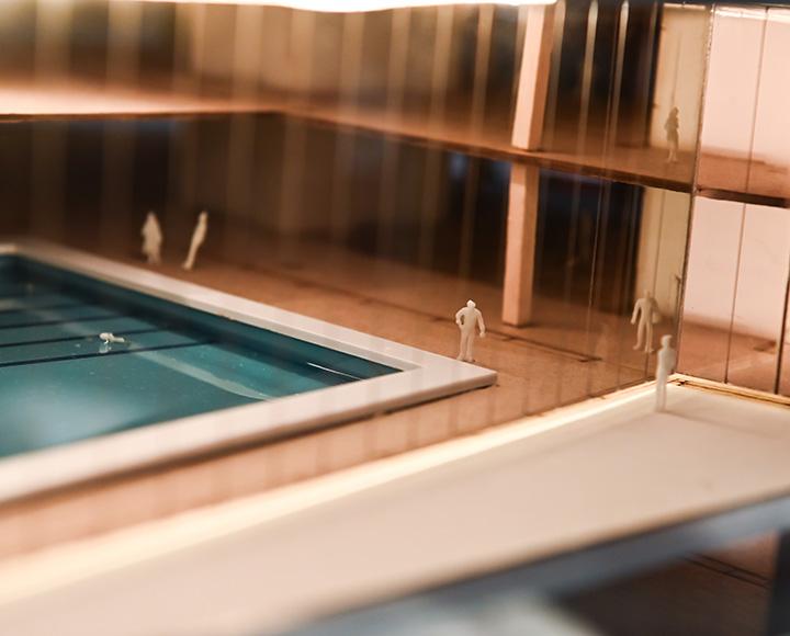 Miniature people use a pool in the campus recreation center model