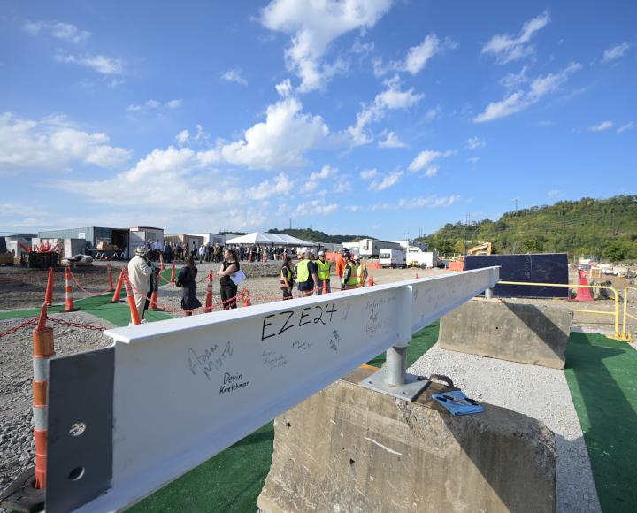 The final steel beam of the BioForge structure, on the ground to be signed