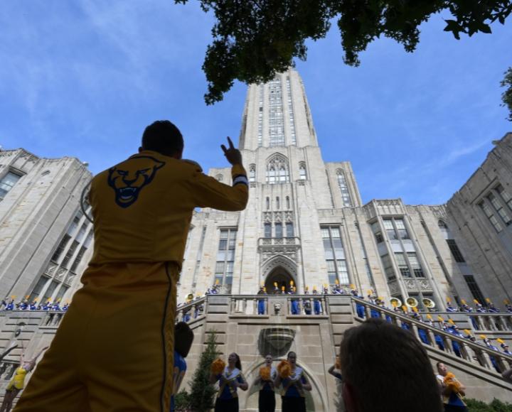 A drum major leads the Pitt Band during a performance at the Cathedral.