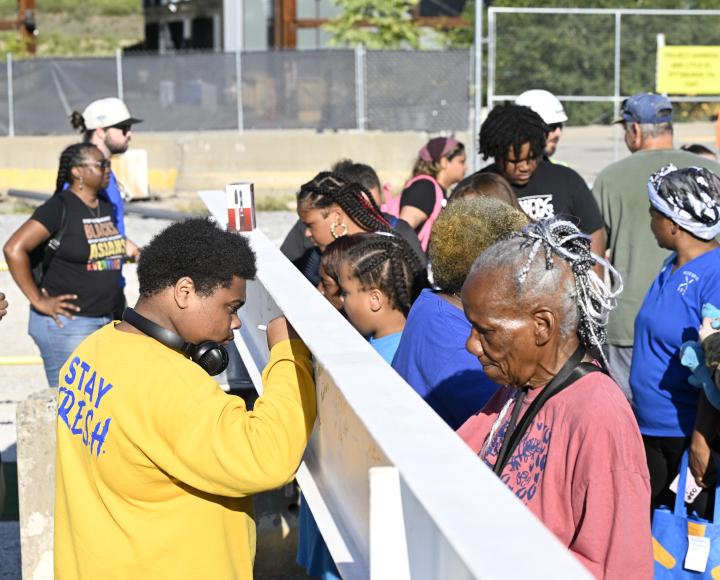 Greater Hazelwood community members sign the BioForge beam