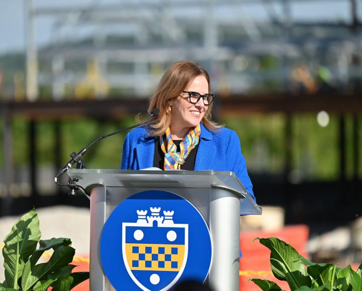 Chancellor Joan Gabel at a Pitt-branded podium