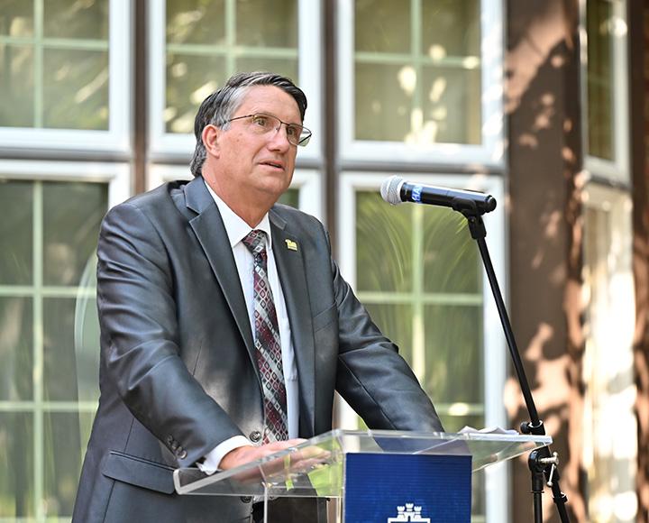 President Robert Gregerson at a podium