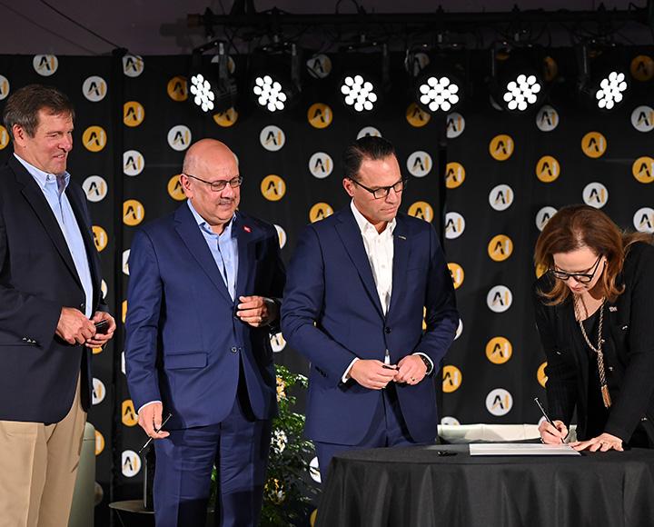 Robbins, Jahanian and Shapiro watch Gabel sign the MOA