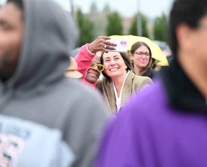 Two people in a crowd take a selfie