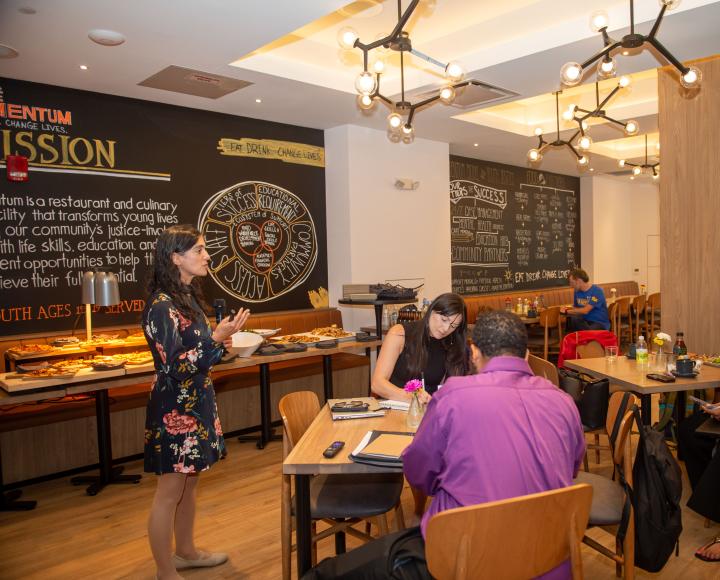The Nonprofit Capacity Building Program participants and advisors meet during an event at Café Momentum.